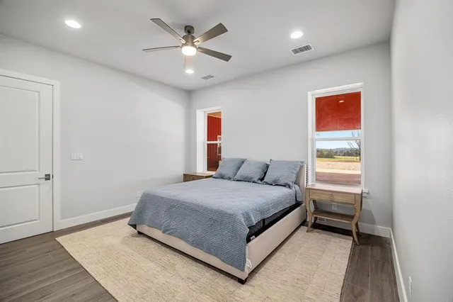 a spacious bedroom with a bed and a window