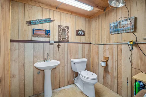 a bathroom with a toilet sink and shower