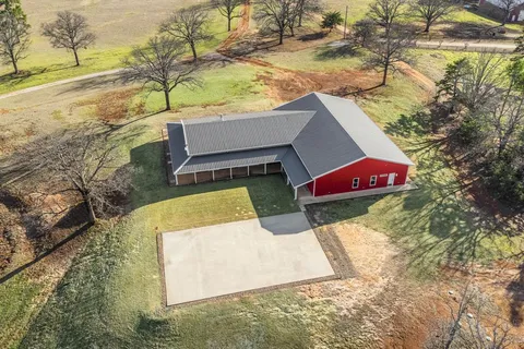 a view of wooden fence and a house in the background