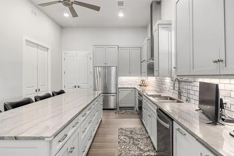 a kitchen with stainless steel appliances a sink stove and refrigerator