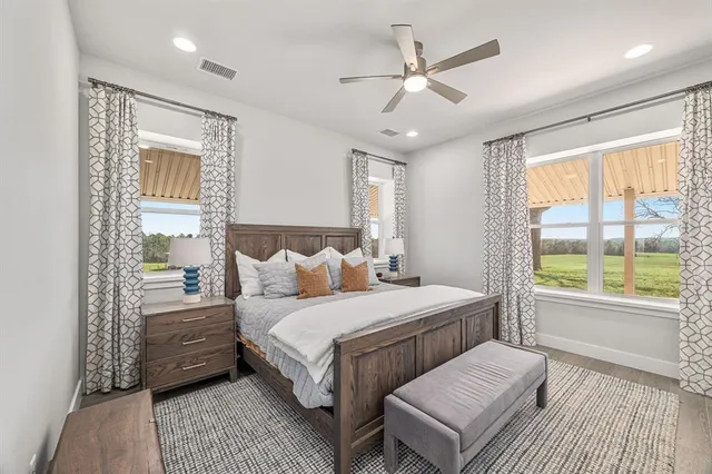 a bedroom with a large bed and a large window