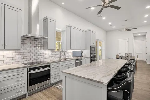 a kitchen with a stove a sink and a refrigerator