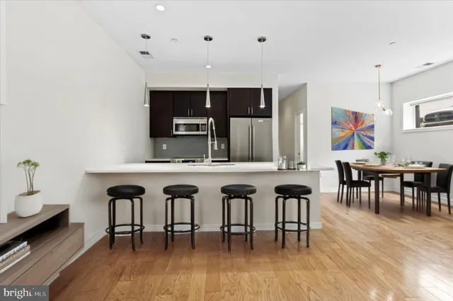 a dining room with furniture and wooden floor