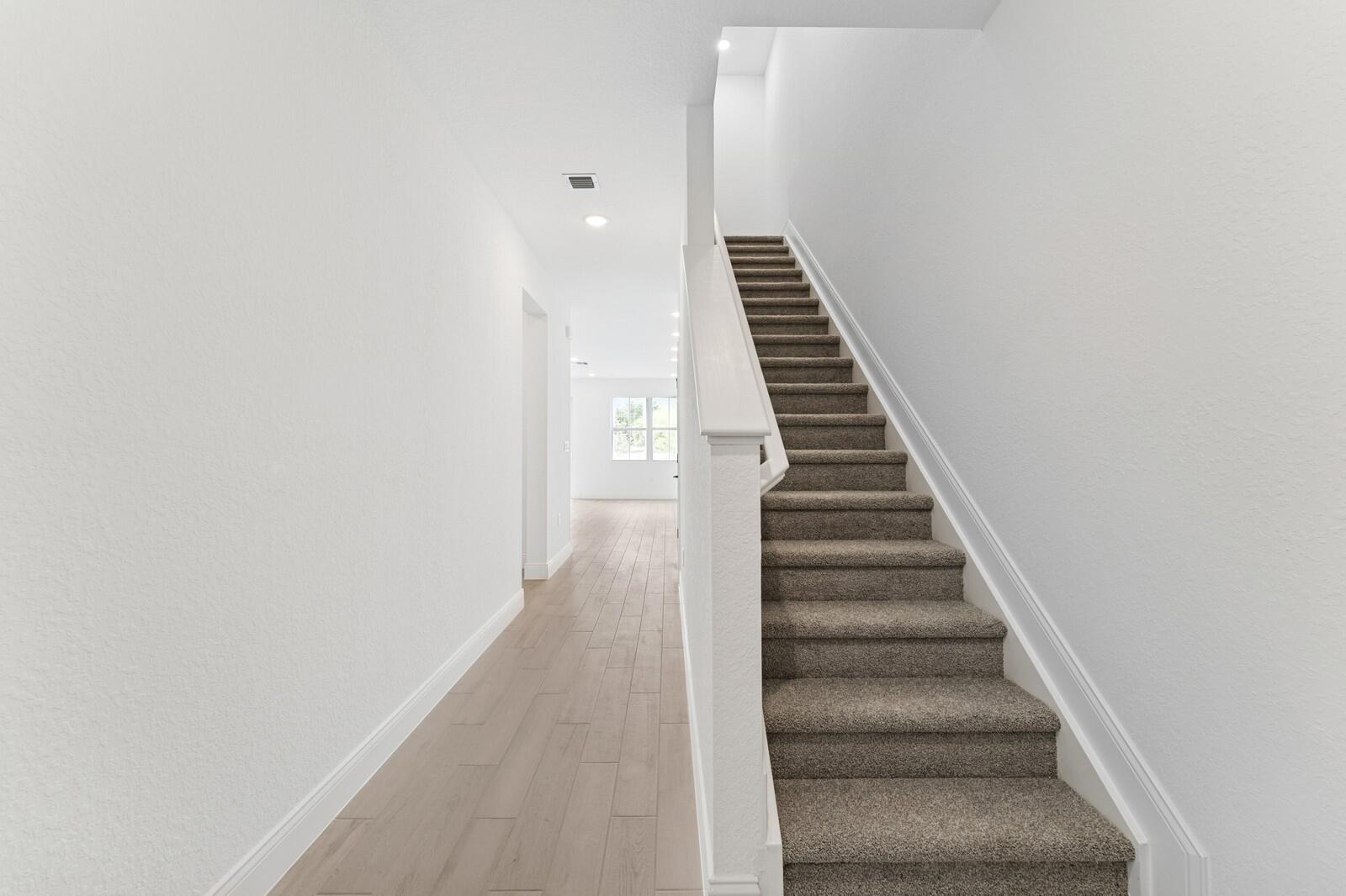 a view of a hallway with stairs