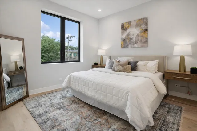 a bedroom with a bed and a painting on the wall