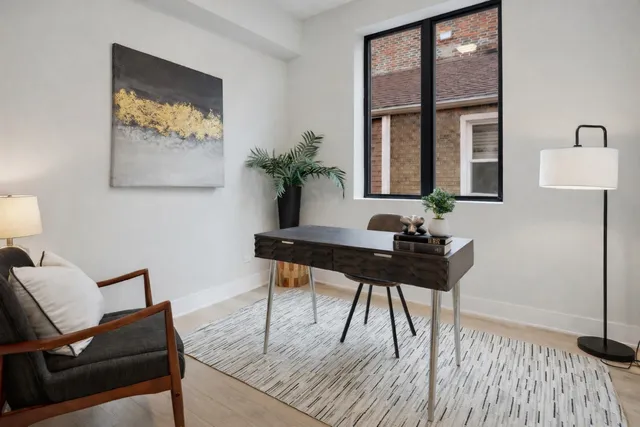 a view of a workspace with furniture and a potted plant