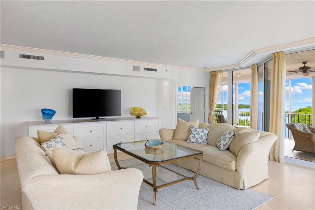 435 Dockside Drive, Unit A804 Naples, FL 34110 - Photo 12 of 50 Living room with crown molding and ceiling fan