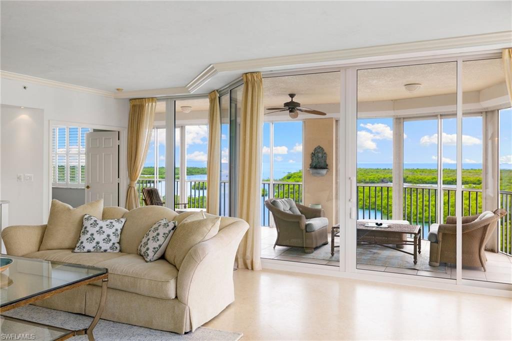 435 Dockside Drive, Unit A804 Naples, FL 34110 - Photo 13 of 50 Living room featuring a water view, ornamental molding, and a ceiling fan