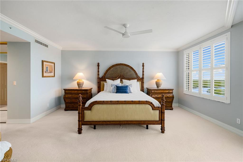 435 Dockside Drive, Unit A804 Naples, FL 34110 - Photo 19 of 50 Carpeted bedroom with crown molding and a ceiling fan