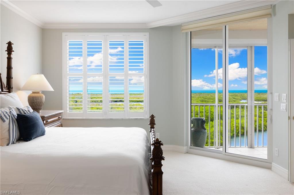 435 Dockside Drive, Unit A804 Naples, FL 34110 - Photo 21 of 50 Carpeted bedroom with multiple windows, access to exterior, a water view, crown molding, and ceiling fan