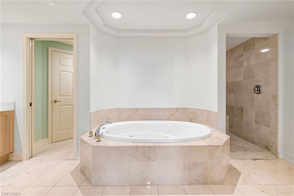 435 Dockside Drive, Unit A804 Naples, FL 34110 - Photo 22 of 50 Bathroom with a garden tub, light tile patterned floors, walk in shower, vanity, and recessed lighting