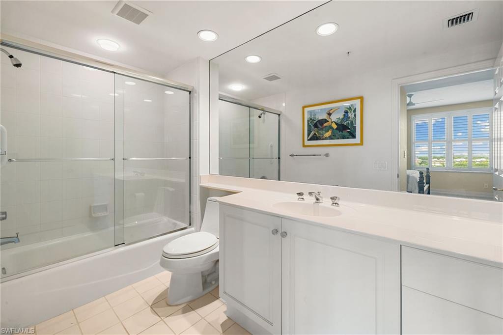 435 Dockside Drive, Unit A804 Naples, FL 34110 - Photo 30 of 50 Bathroom featuring combined bath / shower with glass door, light tile patterned floors, vanity, and recessed lighting