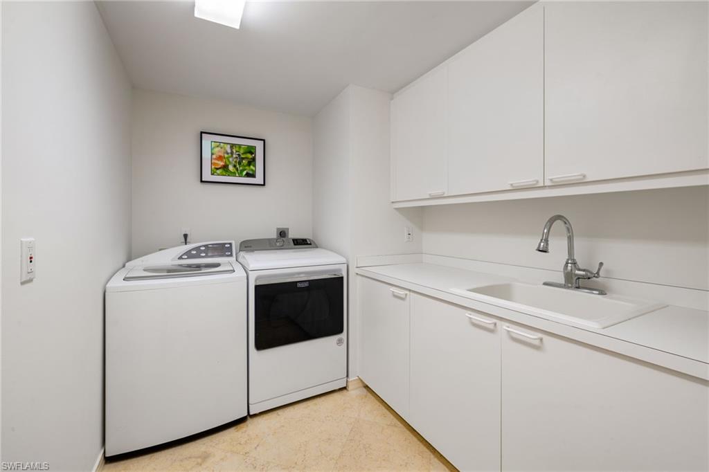435 Dockside Drive, Unit A804 Naples, FL 34110 - Photo 34 of 50 Laundry area with cabinet space and separate washer and dryer