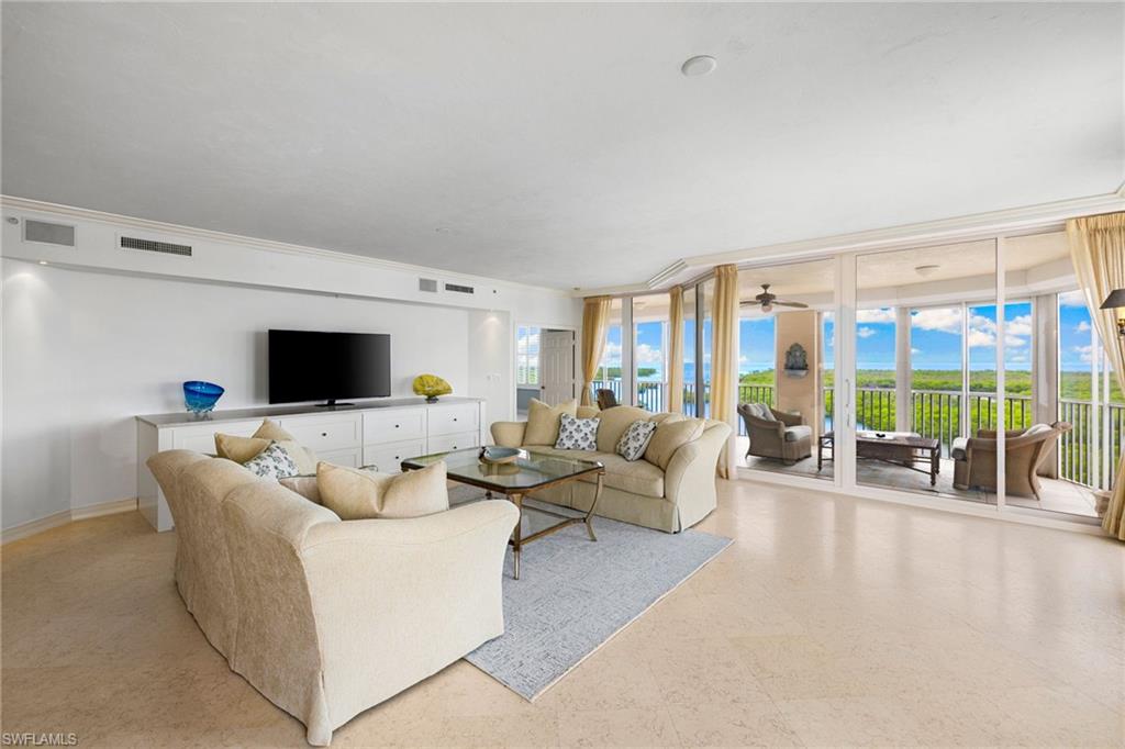 435 Dockside Drive, Unit A804 Naples, FL 34110 - Photo 10 of 50 Living room featuring expansive windows and baseboards