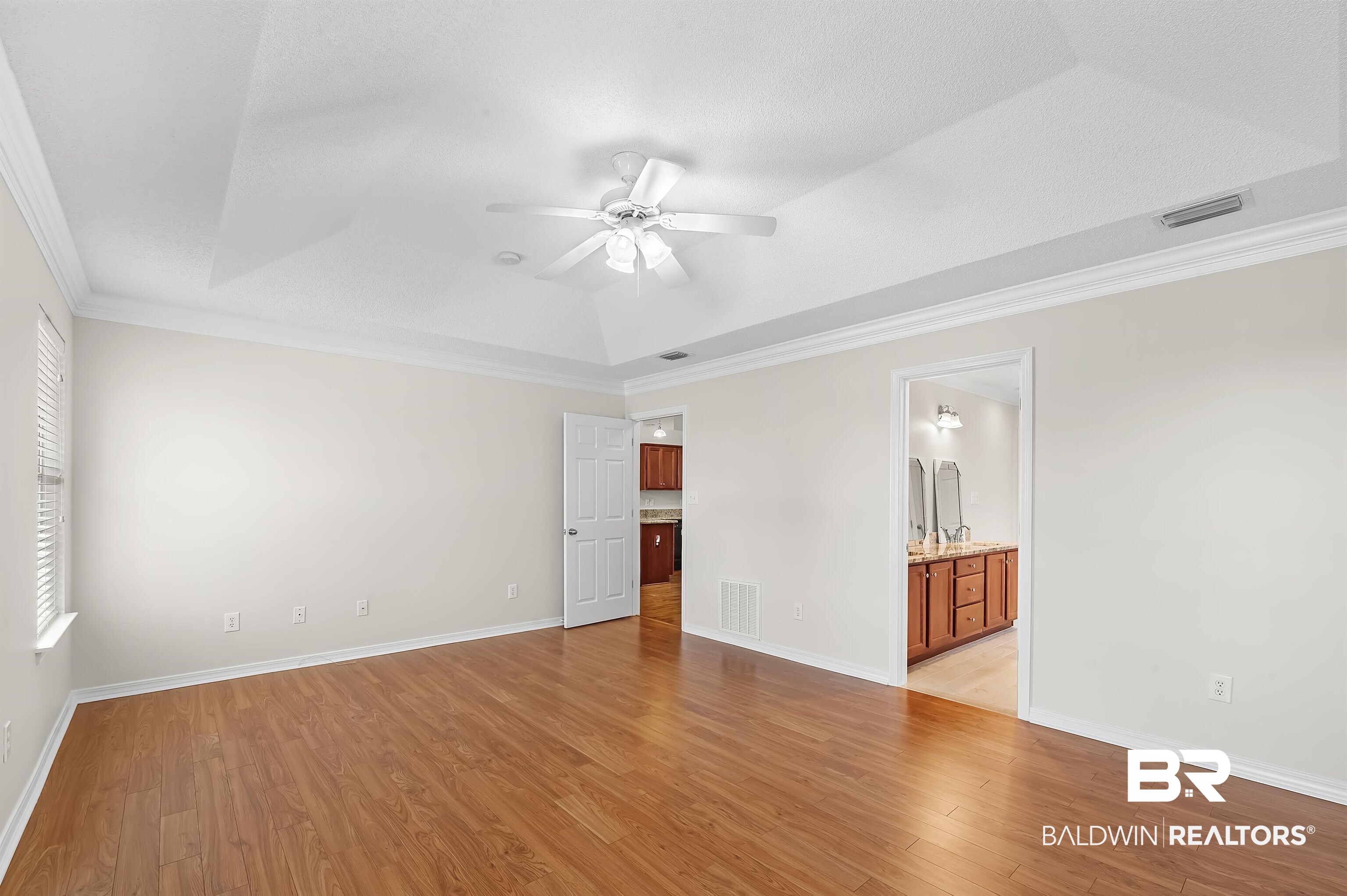 421 Collinwood Loop Foley, AL 36535 - Photo 35 of 62 Spare room with light hardwood / wood-style floors, crown molding, a raised ceiling, and ceiling fan