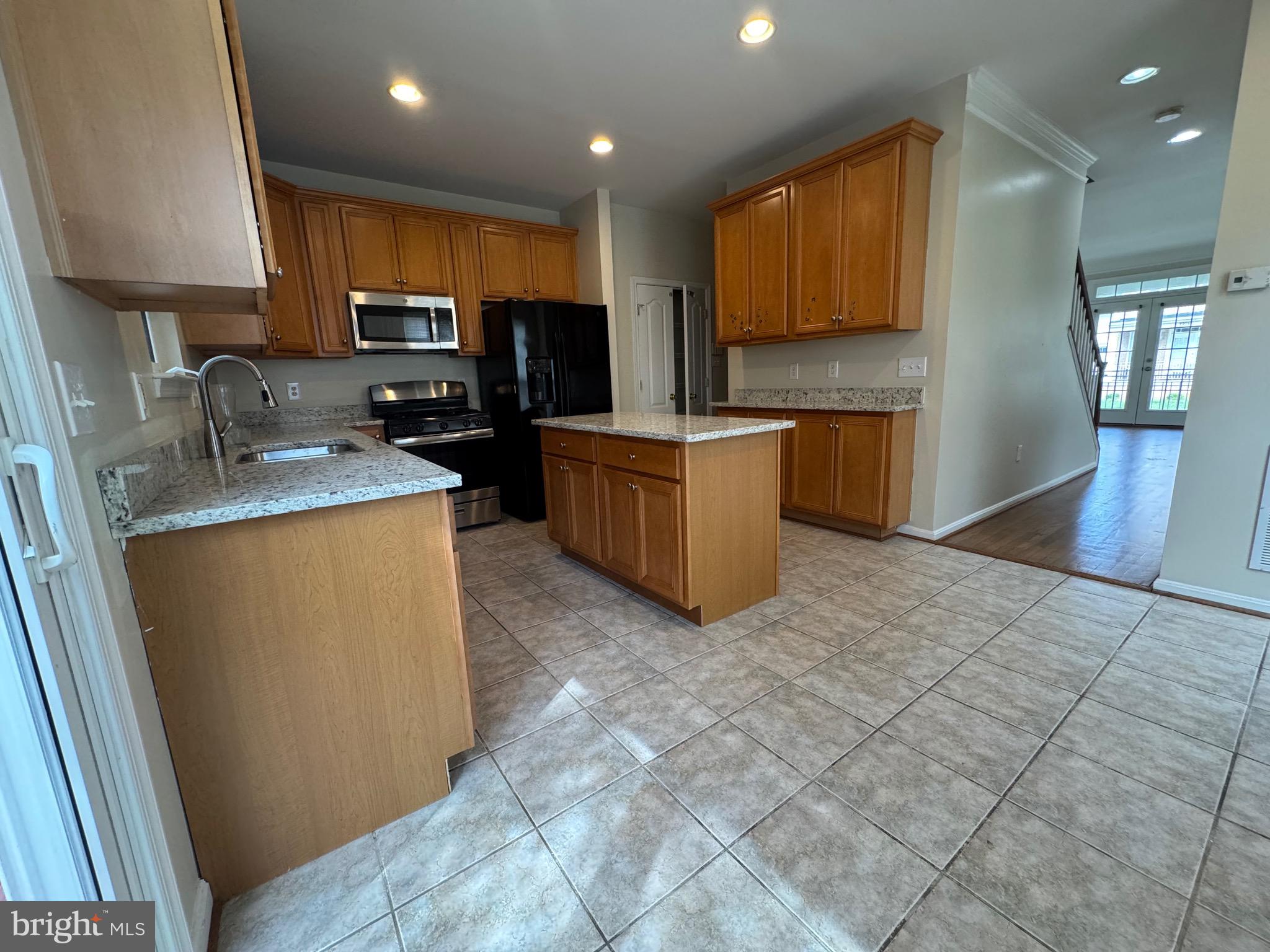 1905 Scaffold Way Odenton, MD 21113 - Photo 11 of 30 a kitchen with stainless steel appliances granite countertop a refrigerator stove microwave and sink