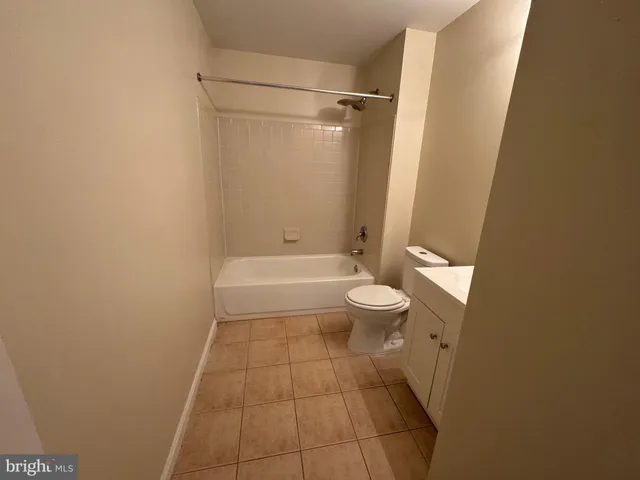 an empty room with wooden floor and entrance