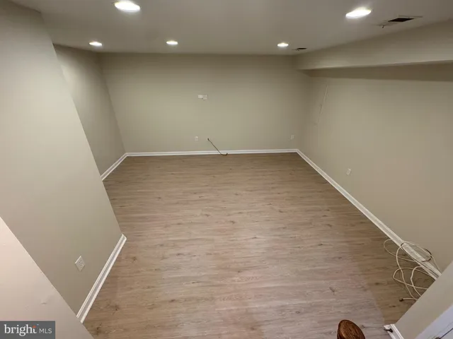 wooden floor in an empty room with windows
