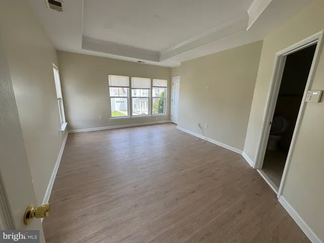 a view of hallway with wooden floor