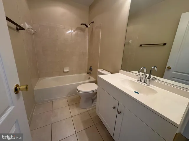 a spacious bathroom with a toilet sink and mirror