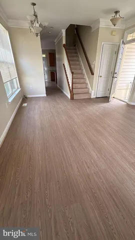 wooden floor in an empty room with a fireplace