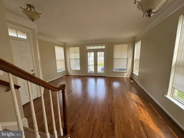 a view of an entryway with wooden floor and windows