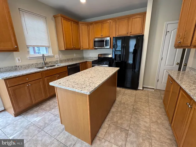 a kitchen with a sink stove and refrigerator