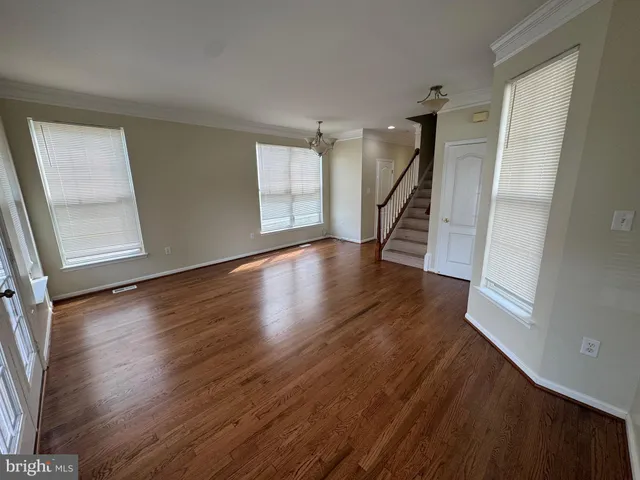 a view of entryway with wooden floor and stairs