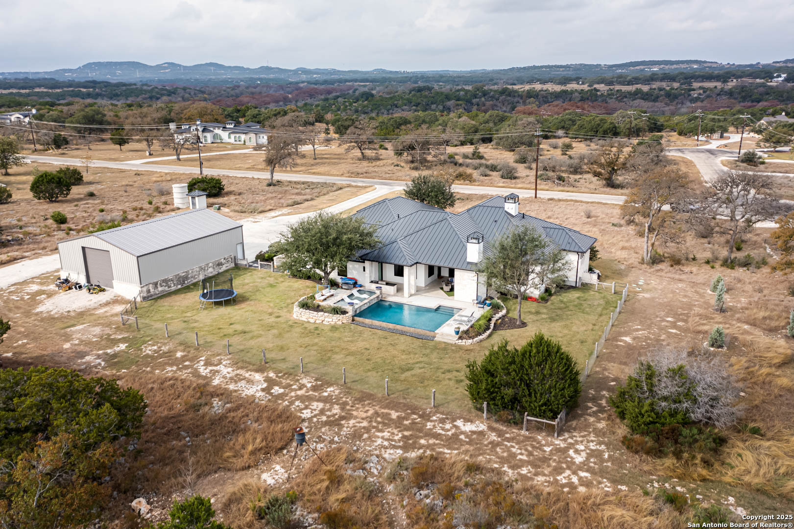an aerial view of residential houses with outdoor space and river