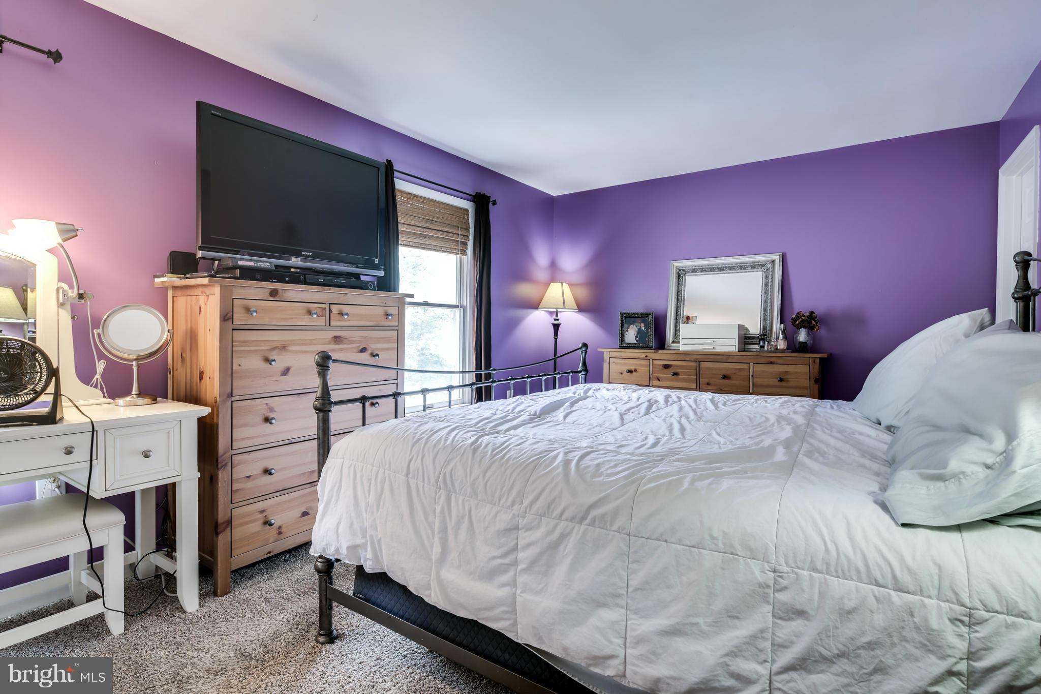 27 Robin Ridge Court Baltimore, MD 21234 - Photo 12 of 18 a bedroom with a bed and a flat screen tv
