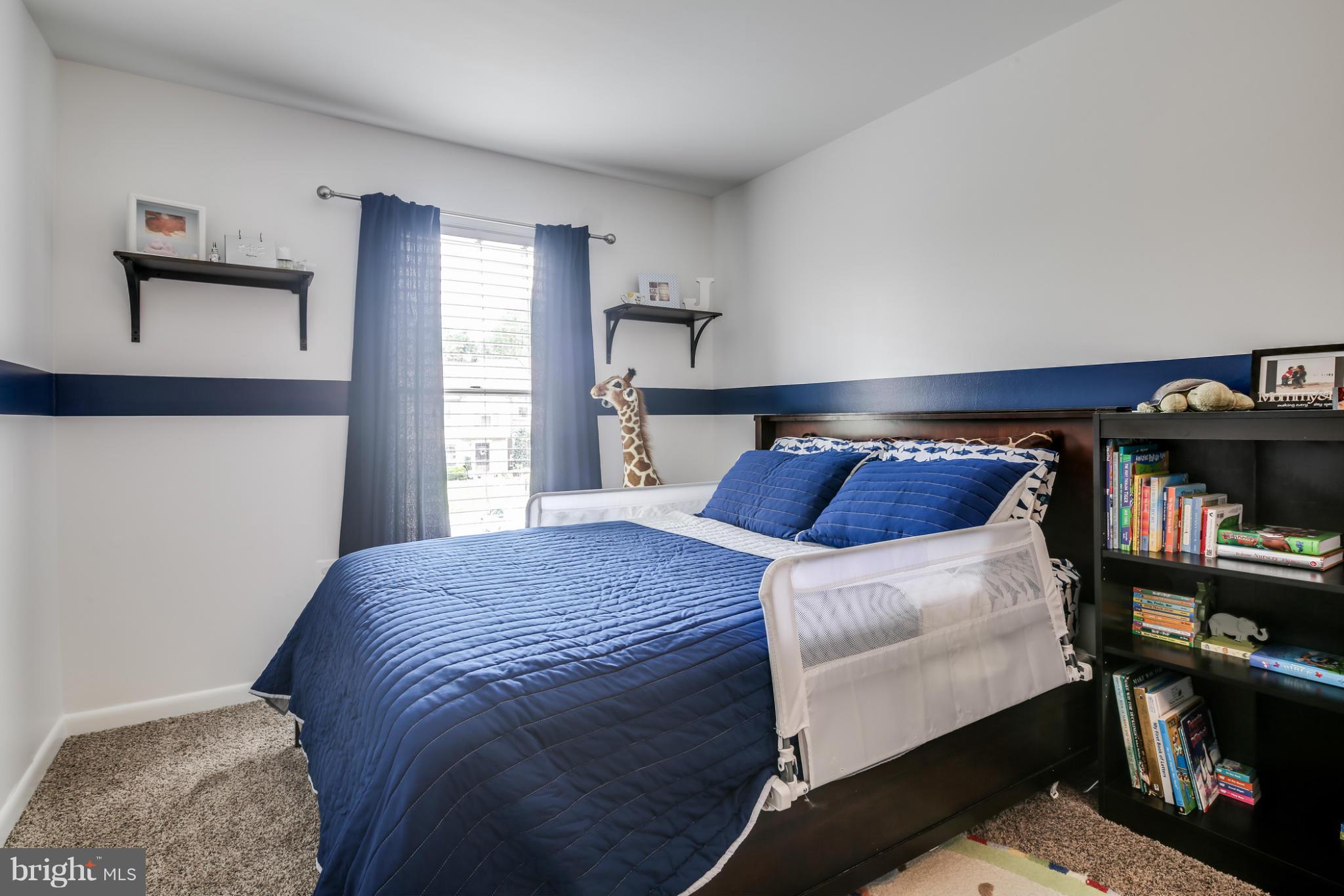 27 Robin Ridge Court Baltimore, MD 21234 - Photo 16 of 18 a bed sitting in a bedroom next to a window