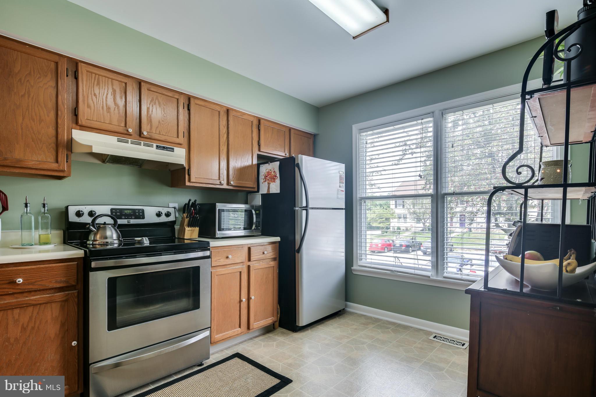 27 Robin Ridge Court Baltimore, MD 21234 - Photo 4 of 18 a kitchen with stainless steel appliances granite countertop a stove a refrigerator and a refrigerator