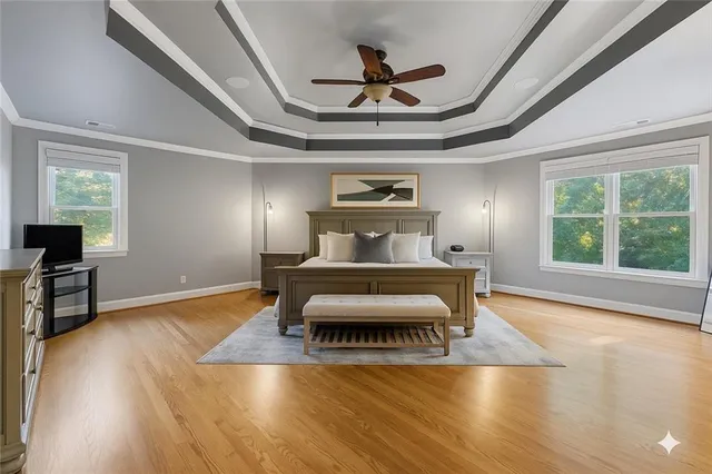 a bedroom with a bed wooden floor and a potted plant