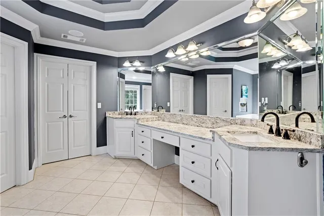 a bathroom with a granite countertop sink a toilet and a mirror