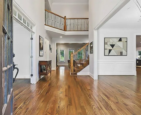a living room with furniture a fireplace and a large window