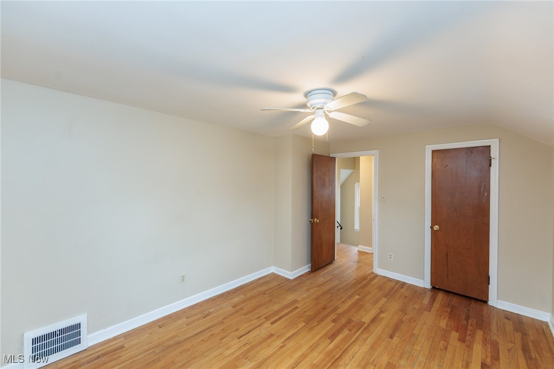 1232 Avondale Road Cleveland, OH 44121 - Photo 27 of 46 Unfurnished bedroom featuring a ceiling fan, light wood-type flooring, visible vents, and baseboards