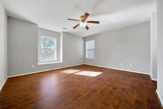 wooden floor in an empty room with a window