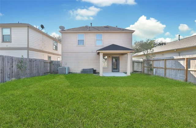 a view of a house with a yard and sitting area