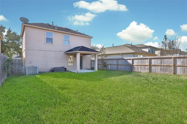 a view of a house with a backyard