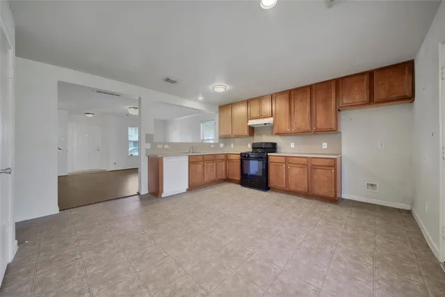 a view of kitchen with wooden cabinet and stainless steel appliances