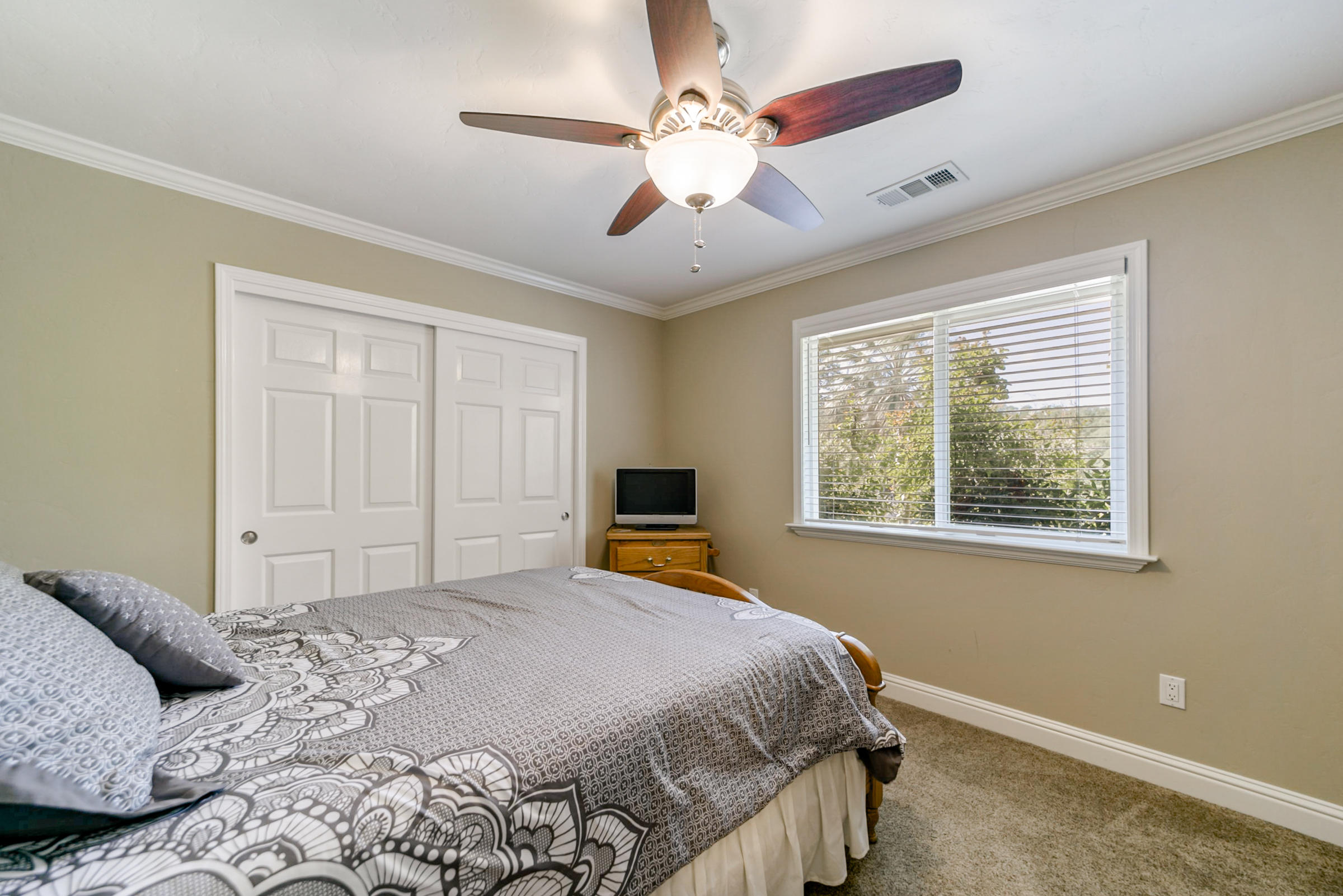 14385 Del Oro Court Red Bluff, CA 96080 - Photo 29 of 33 a bedroom with a large bed and a window