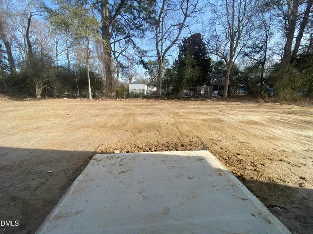 a view of a house with a yard and fence