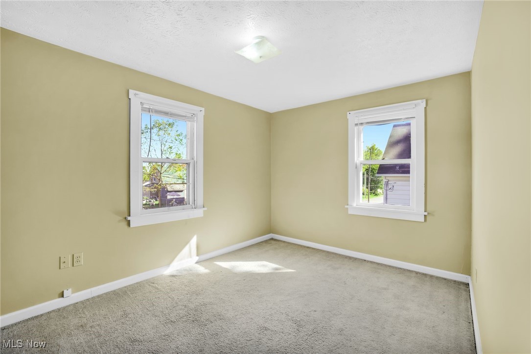 17 Ganyard Street Rittman, OH 44270 - Photo 7 of 16 Carpeted spare room with baseboards and a textured ceiling