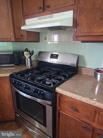 a stove top oven sitting inside of a kitchen