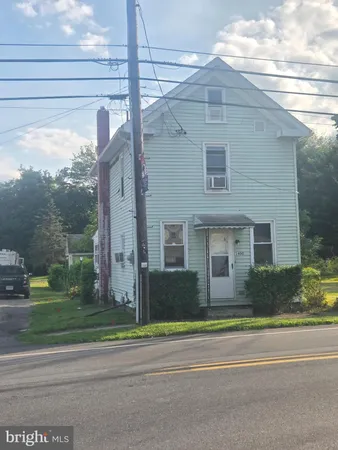 a view of a brick building next to a yard