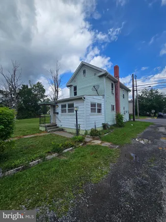 a view of a grassy field with trees