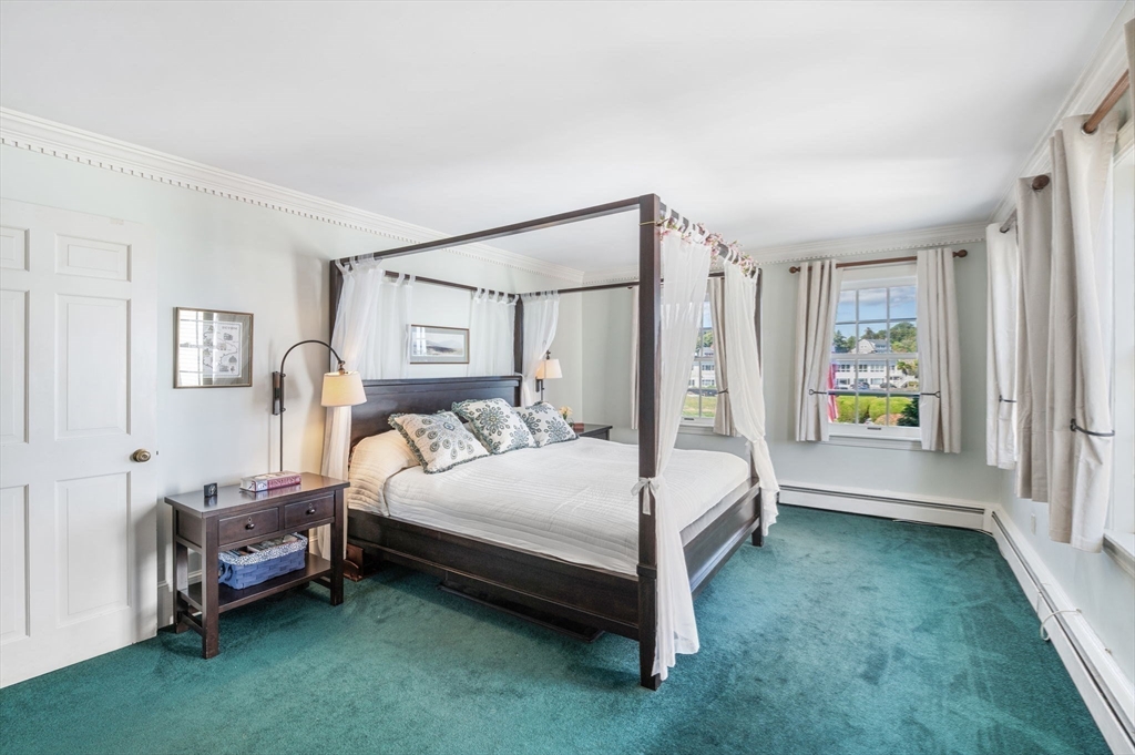 19 Doaks Lane Marblehead, MA 01945 - Photo 16 of 39 a bedroom with a bed table and a window