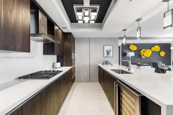 a kitchen with stainless steel appliances granite countertop a stove a sink dishwasher and cabinets with wooden floor