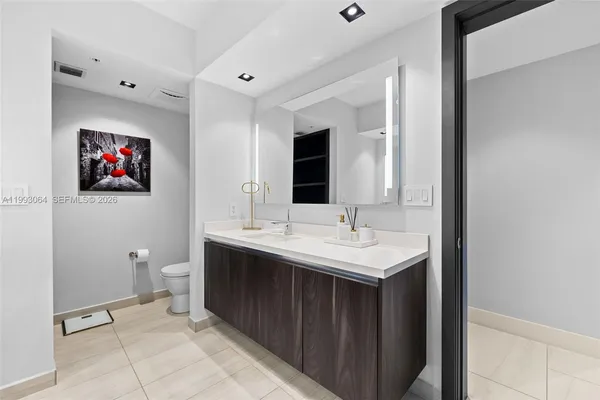 a view of a bathroom sink mirror and toilet