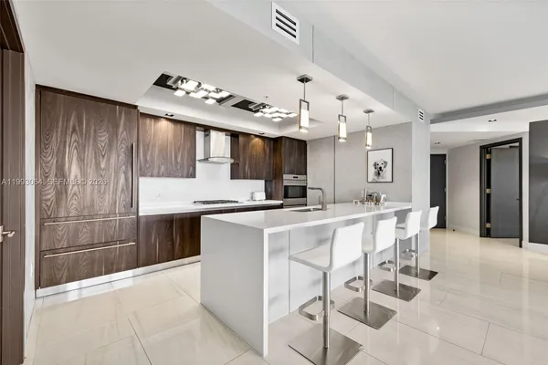 a kitchen with cabinets and chairs